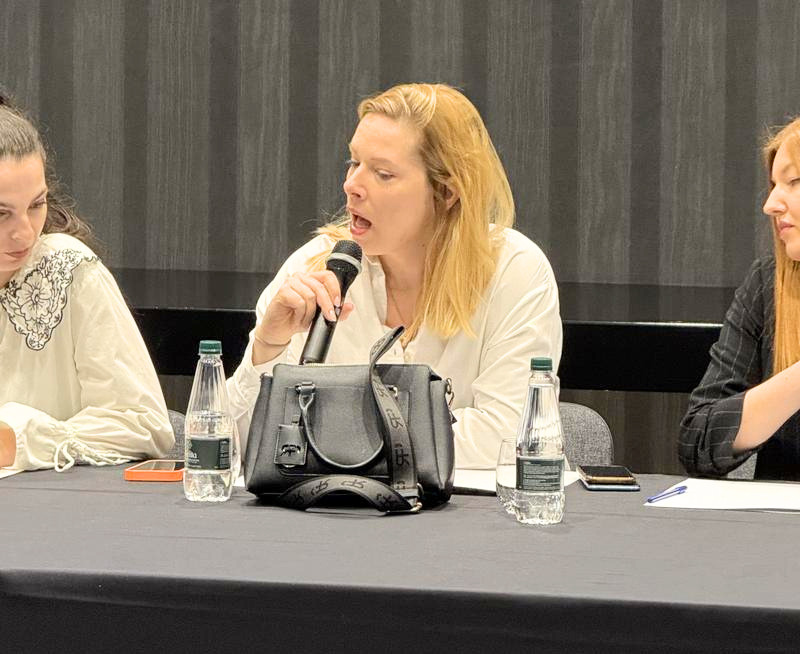 Female workshop delegate speaking into a microphone