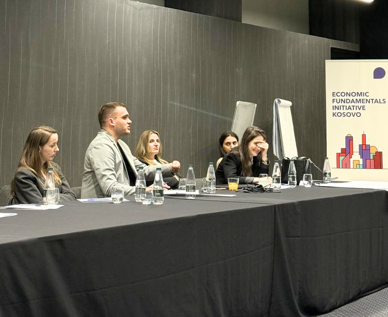 Workshop delegates engaging in conversation at a table