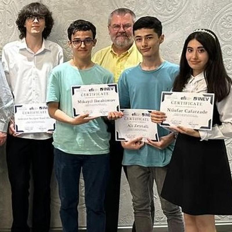 Joe Calhoun stood with four students who are proudly holding up certificates