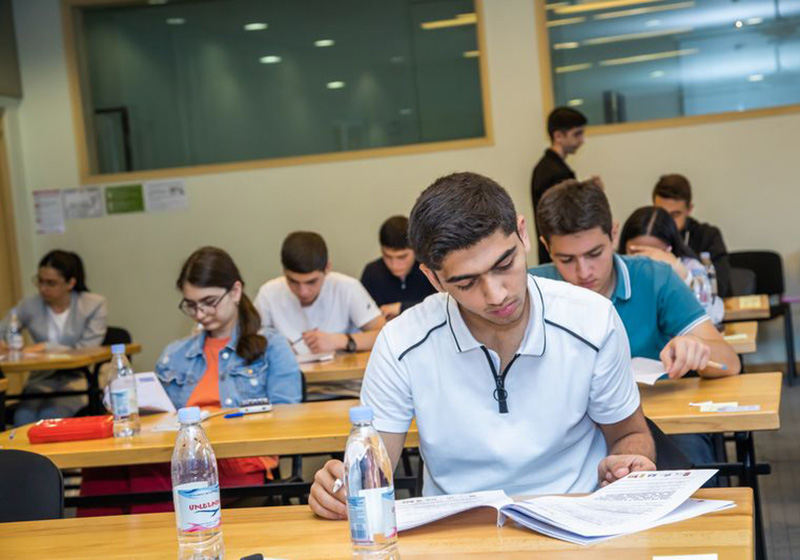 Pupils studying, looking in concentration at their desks