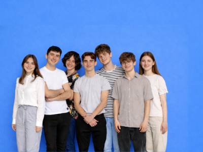 Seven young students looking at the camera with smailing faces